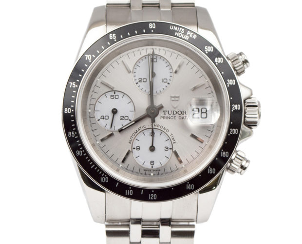 Tudor Prince Date Chrono Watch with silver dial, bracelet, and subdial. The watch has a black bezel with silvertone markers.