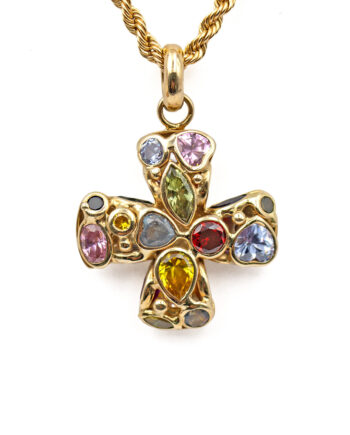 A 14 karat yellow gold, equal-armed cross with various semi-precious gemstones of different shapes and sizes bezel set into both faces of the pendant. The cross has a yellow gold o-ring bail that is shown with a rope chain threaded through it.