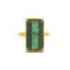 Rectangular green tourmaline with a gold braided bezel on a yellow gold shank.