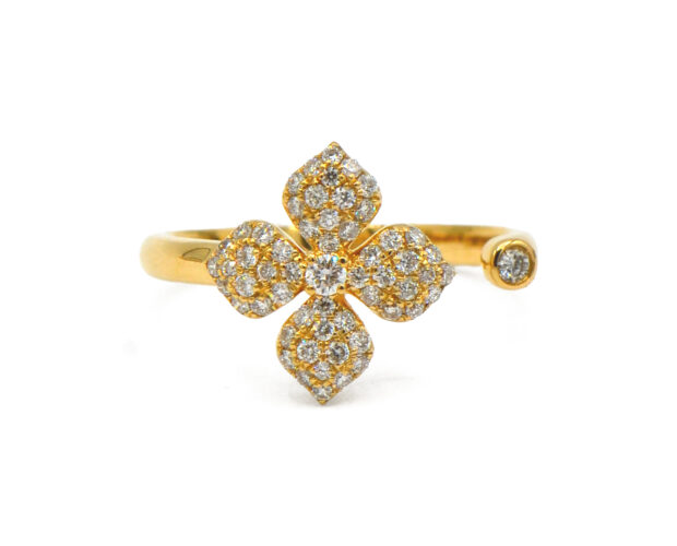 Floral Pavé Ring with four petals made of yellow gold and diamonds. The ring is open shank, with a bezel set diamond.