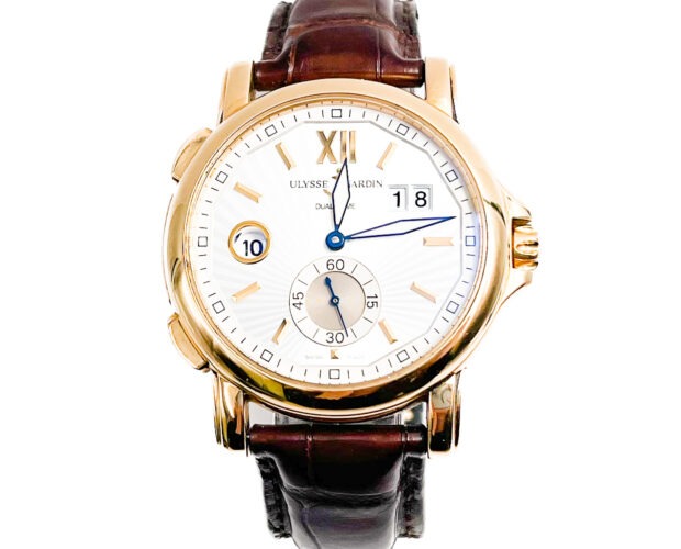 Goldtone Ulysses Nardin Dualtime watch with white dial, bars for markers.