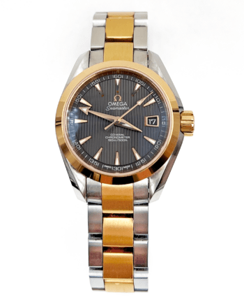 Two tone ladies Omega Seamaster watch. The watch has a dark gray stripe-textured dial, white elongated triangle markers with gold tone borders, and there is a date window on the dial at three o'clock.